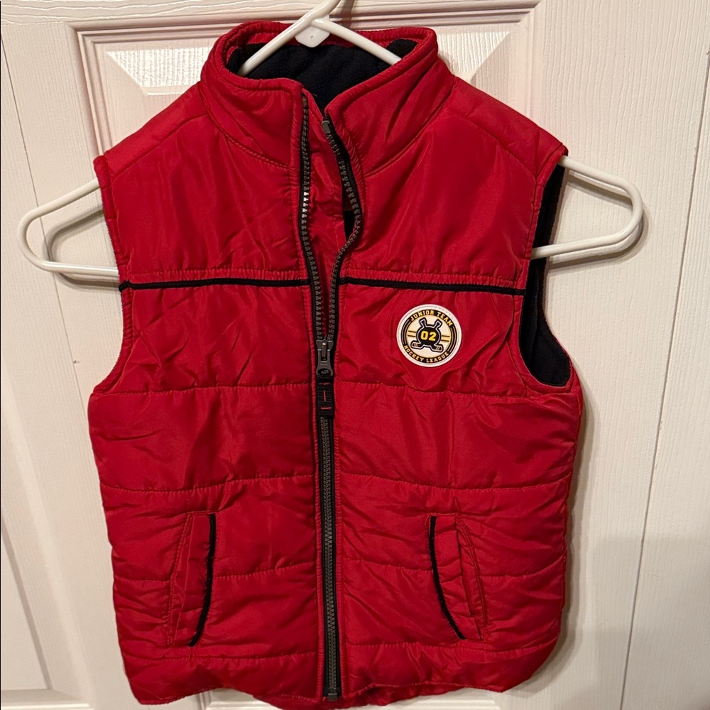 Carter's Bright Red Kids Puffer Vest with Ice Hockey Emblem.